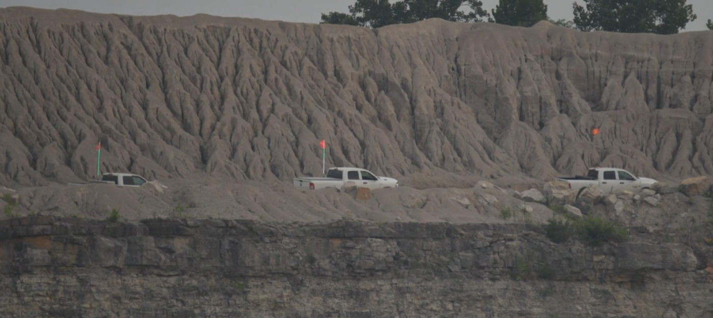 Full LED Buggy Whip, Two Colour LED Buggy Whip and Lit Top Driver Industrial Whip Against a Rugged Mine Backdrop